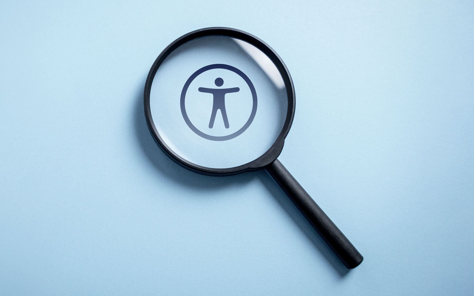 magnifying glass with accessibility icon inside the lens